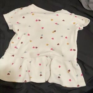 A cute heart polkadot white shirt with bottom ruffles